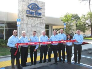 Clay Eye staff cutting ribbon