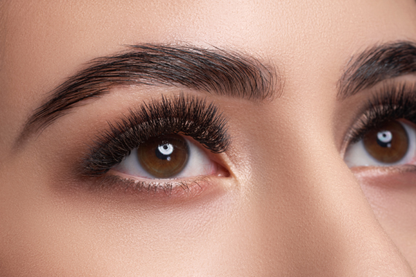 Close up photo of woman's eyes with thick as eyelashes