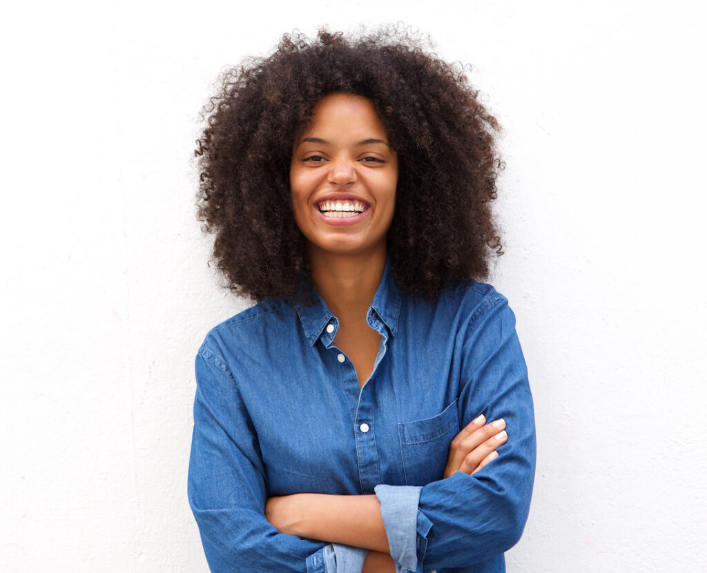 Happy, positive woman standing with arms crossed