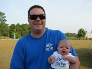 Clay Eye staff holding baby